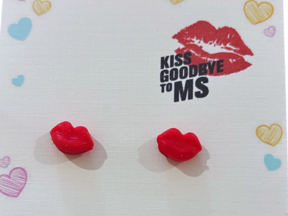 Handmade red lip stud earrings by Emma Larkin Design on display card