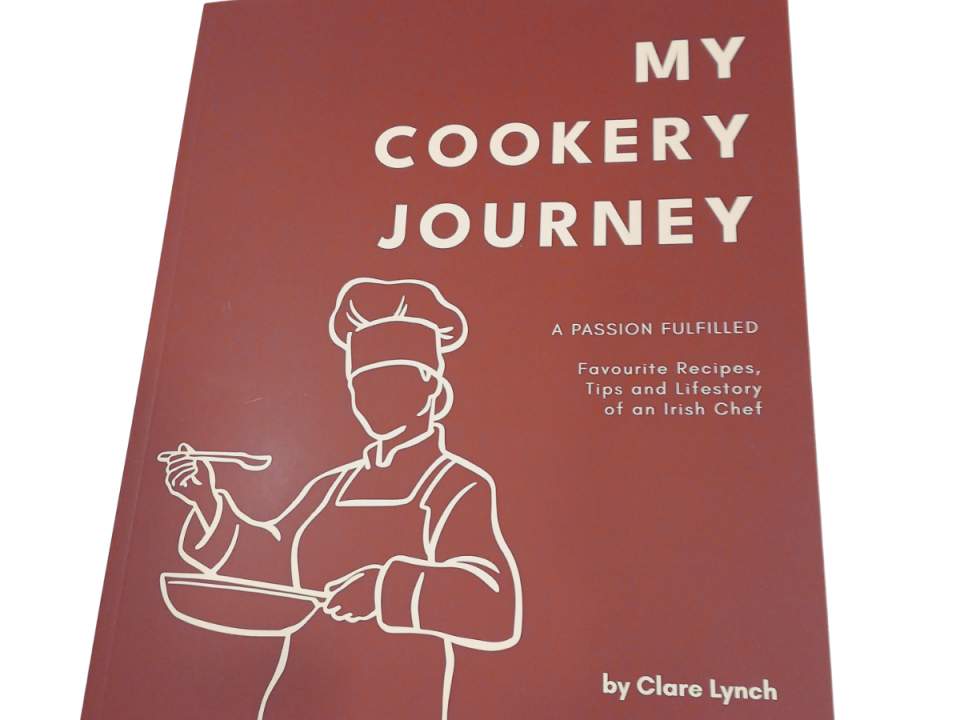 Cover of the book "My Cookery Journey" by Clare Lynch, featuring a red background with a white line drawing of a chef holding a pan