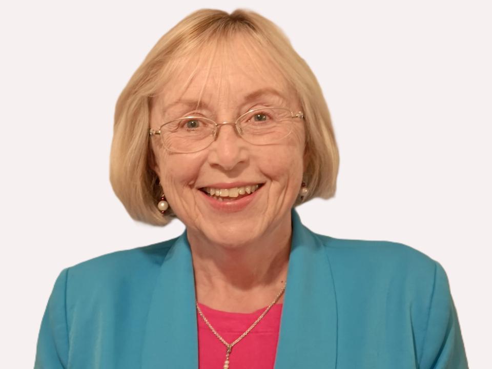 Smiling portrait of a board member with glasses