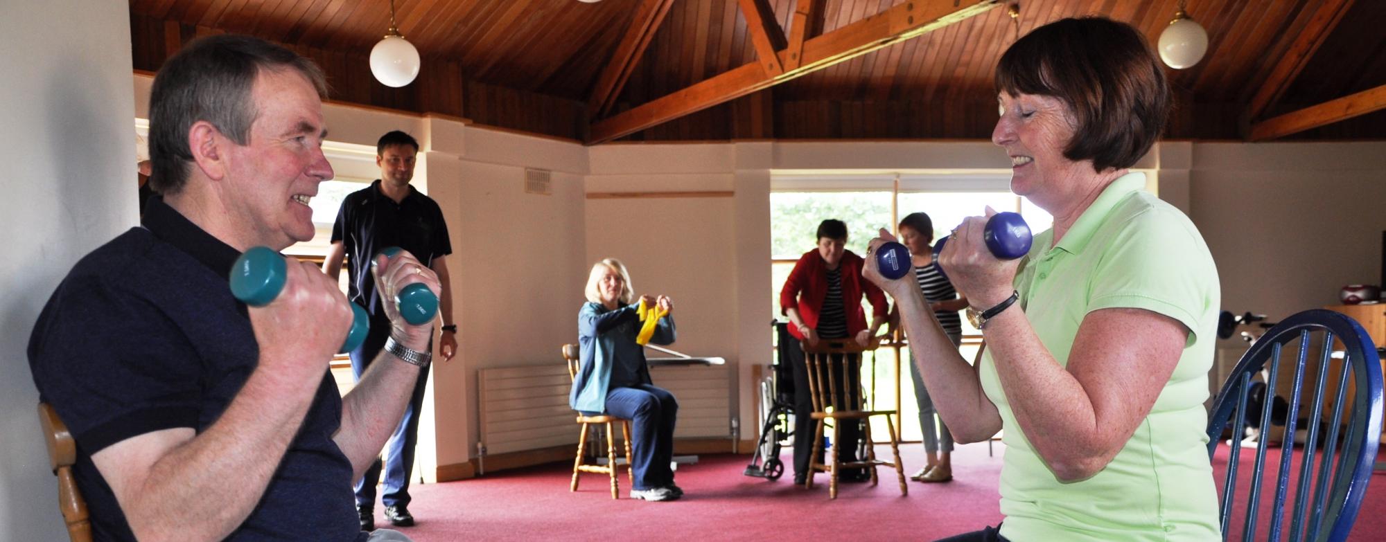 Two people engaging in seated physiotherapy