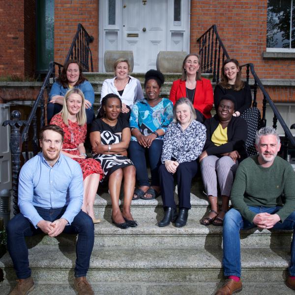 MS Ireland staff sitting on the steps outside the National Office, smiling and posing for a group photo