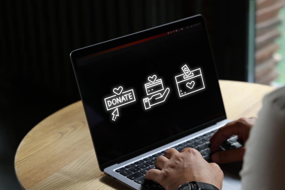 computer on a desk with person on keypad icons on screen